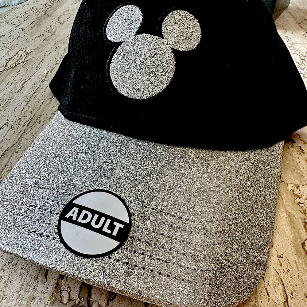 Brand new never worn Disney hat. Black Velcro ball cap with silver glitter